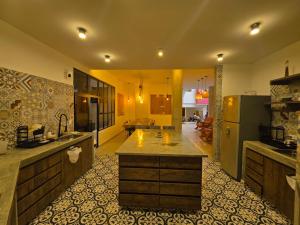 a large kitchen with a large island in the middle at Casa Carmesí Zapatoca in Zapatoca