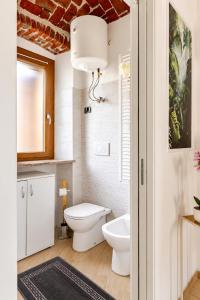 a bathroom with a toilet and a sink at Il Rustico Romantic Suite e Sauna in Ciriè