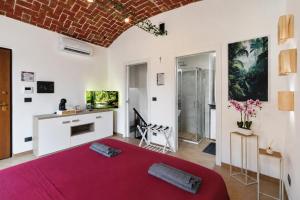 a bedroom with a large red bed in a room at Il Rustico Romantic Suite e Sauna in Ciriè