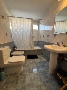 a bathroom with a toilet and a sink at KAD Alojamiento in Mendoza