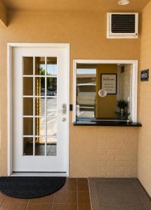 a door to a restaurant with a sign on it at Grapevine Inn in Lodi