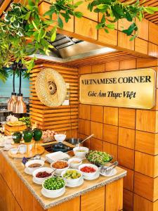 a buffet with bowls of food on a table at Autumn Sea Boutique Hotel in Nha Trang