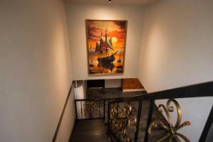 a painting of a ship on a wall next to a staircase at Doña Eneida Cabin in Soná +12 photos