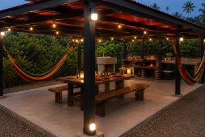 a picnic table under a pavilion with lights at Doña Eneida Cabin in Soná