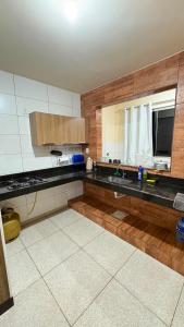 a kitchen with a sink and a counter top at Apart Serra Azul in Santa Bárbara