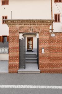 an open door to a brick building with stairs at Il Rustico Romantic Suite e Sauna in Ciriè +13 photos