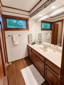 a bathroom with a sink and a mirror at Kaw Drive Guest House in Olathe +17 photos