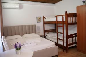 a small room with two bunk beds and a table at ARBERs aparthotel in Durrës
