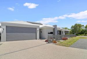 a large white house with a garage at Seahawk Escape in Mandurah