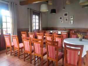 a dining room with a table and a bunch of chairs at Hotel Artea Errota in Zamudio