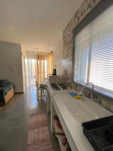 a kitchen with a sink and a counter top at Loft Da Rosa in Rio Grande