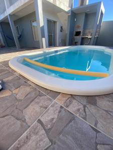 a large swimming pool in front of a building at Loft Da Rosa in Rio Grande