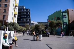 a group of people walking around in a city at The Hideaway Studio-Maboneng in Johannesburg