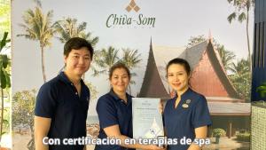 a group of three people holding a certificate in front of a building at Elephantia Spa Hotel in Villa de Leyva