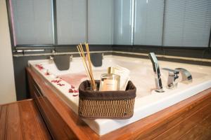 a bathroom sink with a basket of hygiene items on it at LİMONOTTO SUİT OTEL in Mersin +55 photos