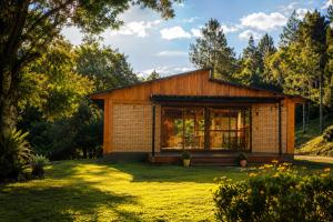 a house with a large window in a yard at Espaço Luna in Gramado