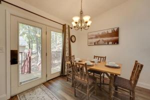 a dining room with a table and chairs and a window at Ozark Mountain Refuge in Kimberling City