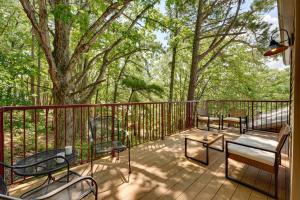a deck with benches and a table and a tree at Ozark Mountain Refuge in Kimberling City +10 photos