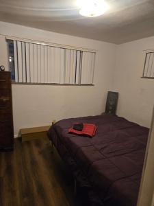 a bedroom with a bed with a red towel on it at Cute and Cozy in Hermann I Heliport