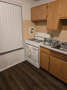 a kitchen with a stove and a sink at Cute and Cozy in Hermann I Heliport