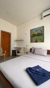 a bedroom with a bed with a blue towel on it at Amazonas magic in Leticia