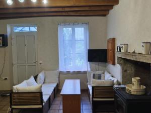 a living room with a couch and a fireplace at Ferme bourbonnaise rénovée avec jardin, animaux admis - FR-1-489-295 in Bransat