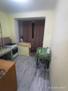 a living room with a room with a table in it at Gazda ialoveni in Ialoveni
