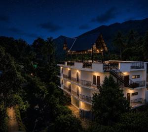 a building at night with lights on at Rivendell resort Munnar in Munnar +26 photos