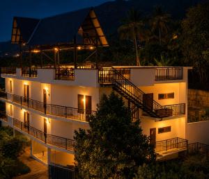a building with stairs and lights at night at Rivendell resort Munnar in Munnar
