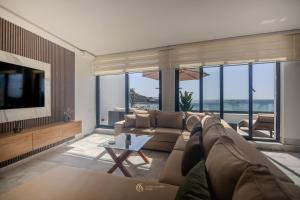 a living room with a couch and a tv at Playablanca Luxury Beach Apartment First Floor in Tanger in Tangier