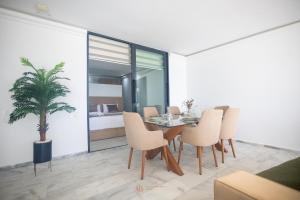 a dining room with a table and chairs and a bedroom at Playablanca Luxury Beach Apartment First Floor in Tanger in Tangier