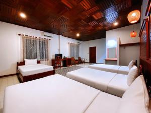 a bedroom with three beds and a living room at ASANA Villas in Siem Reap +68 photos