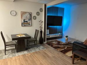 a living room with a table and a dining room at AYBAM's House in Winnipeg