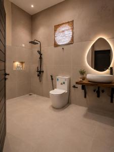 a bathroom with a toilet and a sink at Ella Brown House in Ella +50 photos