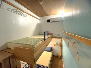 a small room with a bunk bed in it at みーまん奄美 in Amami