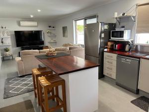 a kitchen and living room with a counter top at 2 bedroom private unit with enclosed back yard in Bairnsdale +11 photos