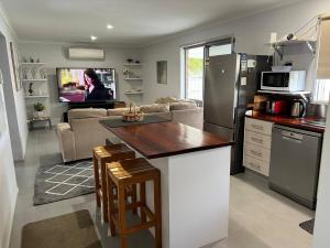 a kitchen and living room with a couch and a table at 2 bedroom private unit with enclosed back yard in Bairnsdale