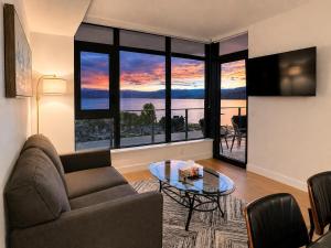 a living room with a couch and a table at Paradise on the Lake in Kelowna