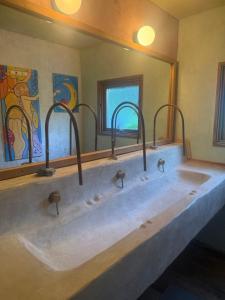 a bathroom with two sinks and a large mirror at Wakaranai Lodge Tomamu in Shimukappu +26 photos