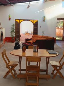 a room with a table and chairs and a bed at Refugio tierra viva in Cusco