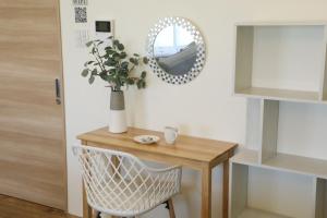 a dining room table with a mirror and a chair at フサキリゾート Ishigaki 201 in Ishigaki Island