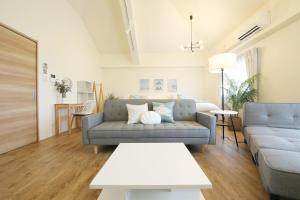 a living room with a couch and a table at フサキリゾート Ishigaki 201 in Ishigaki Island