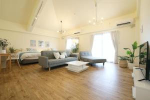 a large living room with a couch and a bed at フサキリゾート Ishigaki 201 in Ishigaki Island +32 photos