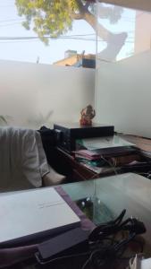 an office with a desk with a glass table with scissors at the moon palace in Agra