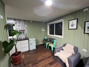 a living room with a couch and a table at Casita Nalca in Chaitén +7 photos