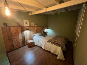 a bedroom with a bed in the corner of a room at Casita Nalca in Chaitén