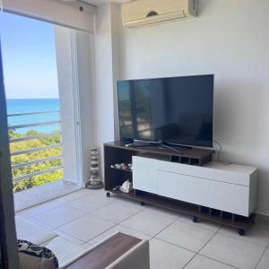 a living room with a large flat screen tv on a cabinet at Apartamento Ocean View in La Chumicosa