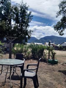 a table and two chairs and a table and a table and chairs at Cabaña Rayantu Antuco in Antuco