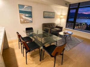 a living room with a glass table and chairs at Paradise on the Lake in Kelowna