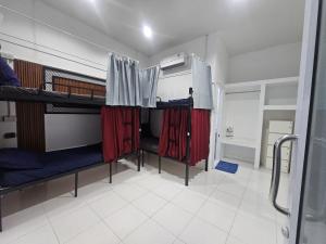 a room with two bunk beds with red curtains at Dive In Koh Tao in Ko Tao